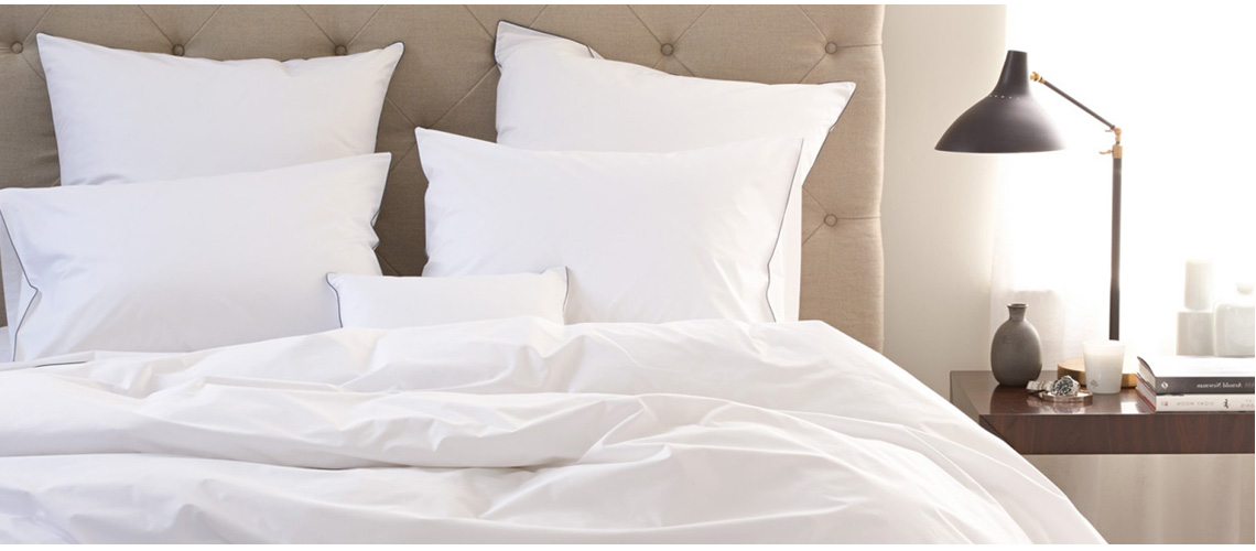 パリッとしたホテル品質のリネンのベッドで眠る
